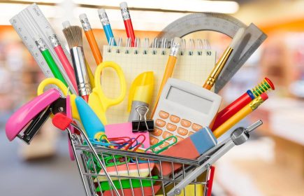 Shopping cart with colorful school stationery, back to school background