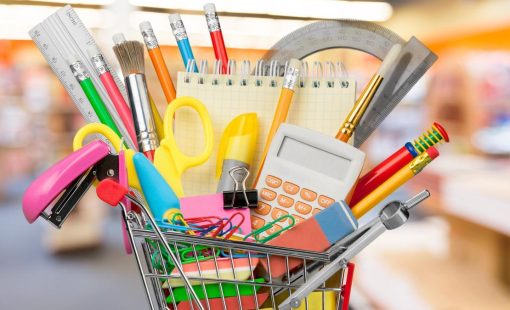 Shopping cart with colorful school stationery, back to school background